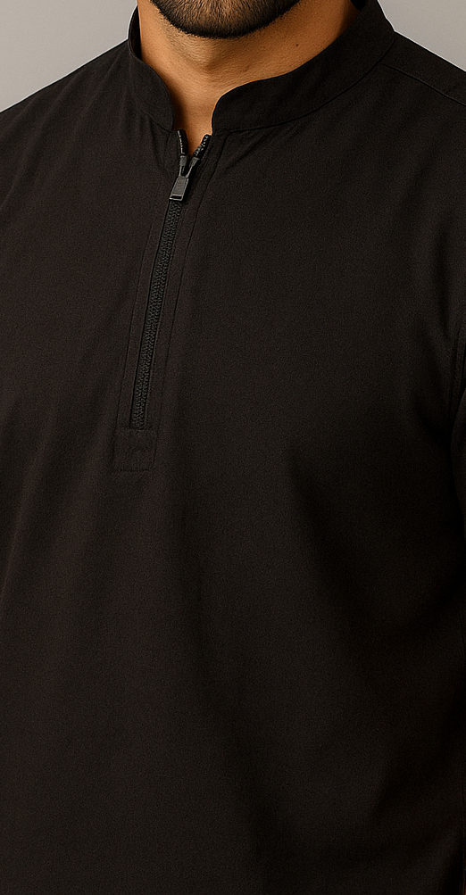 Black zip-up shirt worn by a person on a neutral background