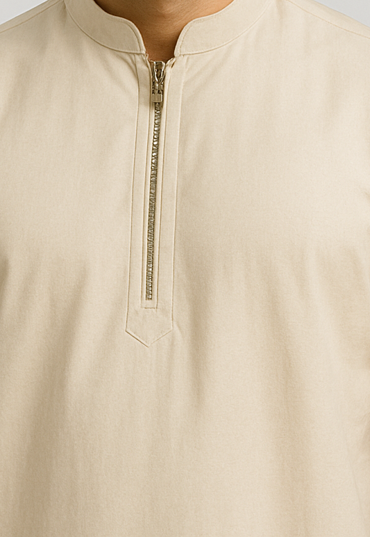 Beige shirt with a zipper detail on a light gray background