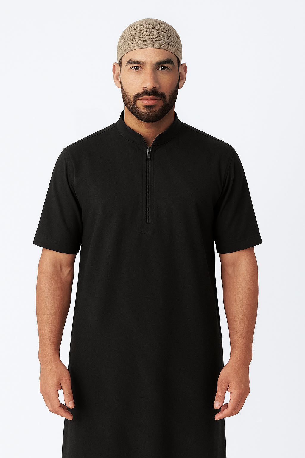 Man wearing a black kurta with a beige cap on a white background
