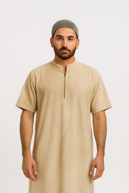 Man wearing a beige long shirt and green cap on a white background