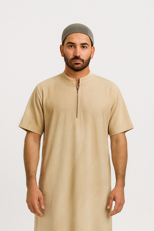 Man wearing a beige long shirt and green cap on a white background