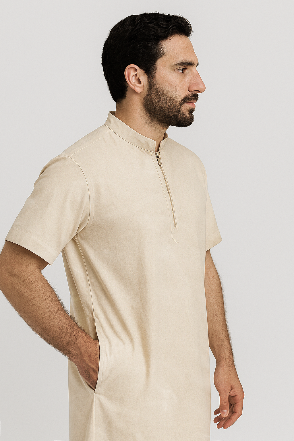 Man wearing a beige kurta against a white background