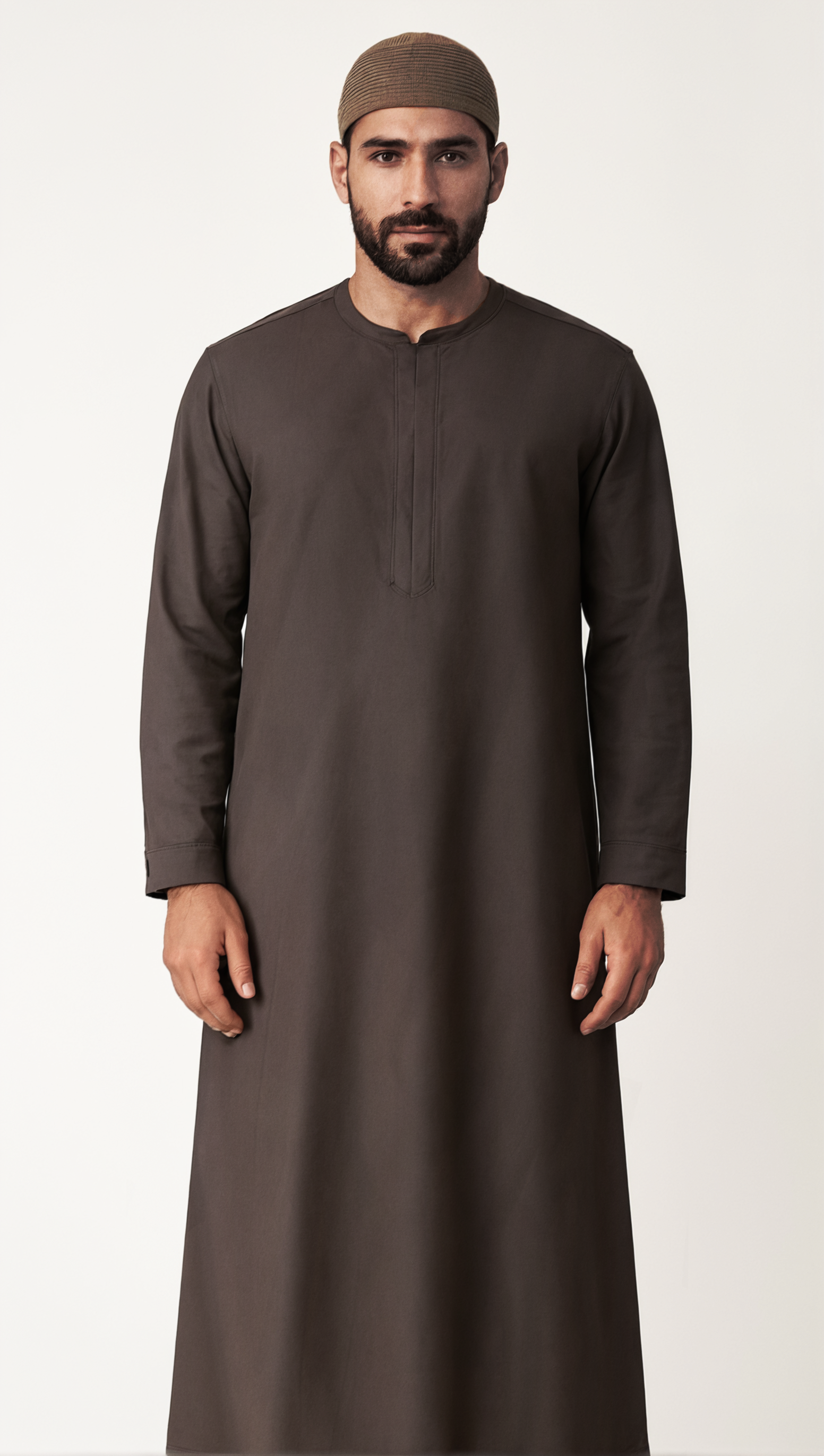 Man wearing a long brown garment and cap on a white background